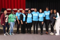 Group wearing custom light blue "I.C.U" t-shirts