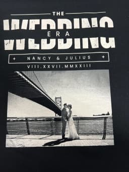 Close-up of the "The Wedding Era" wedding t-shirt print with Nancy & Julius photo