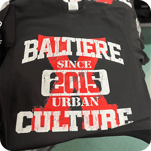 Red and white distressed style screen print on dark apparel for Baltiere Urban Culture since 2015
