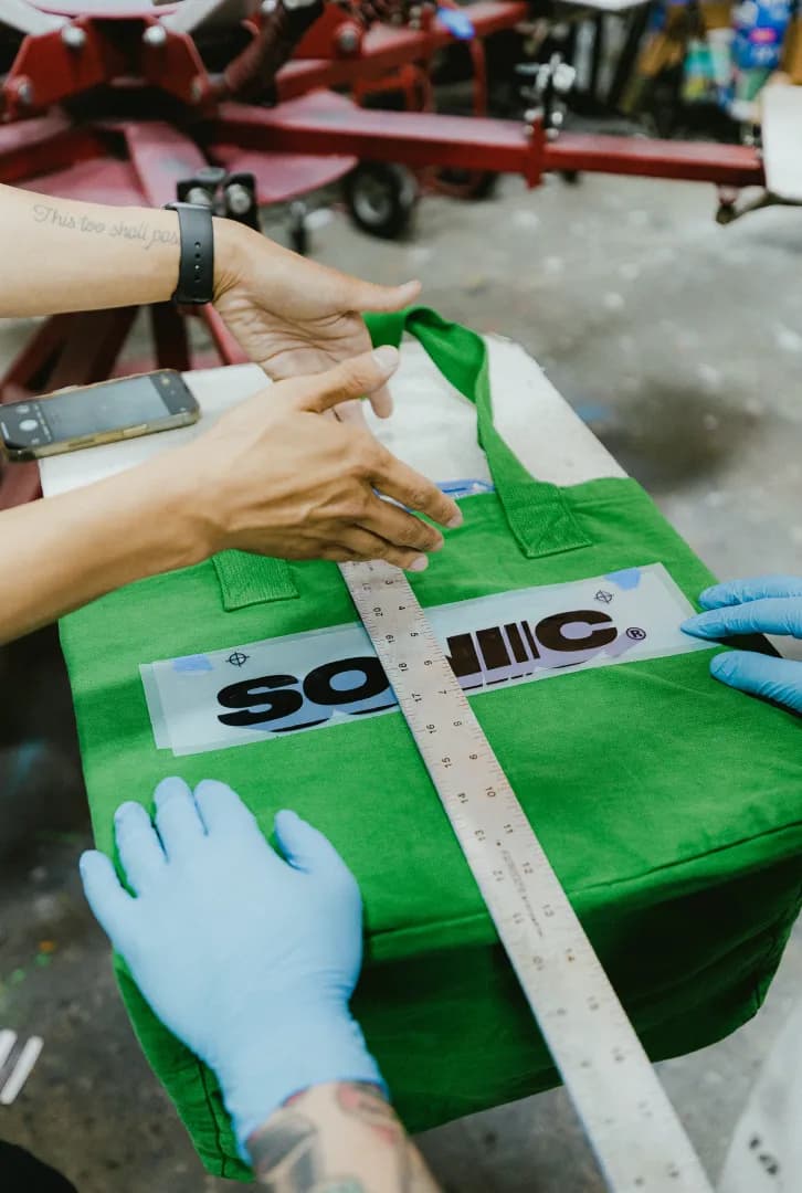 Positioning screen printing shirts during custom screen printing service process