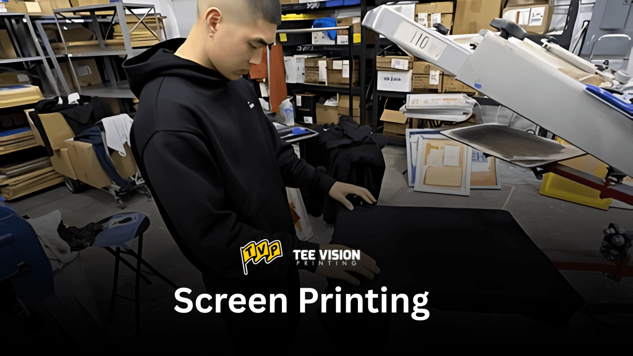 A person loading a garment onto a screen printing press, demonstrating the printing method that works for all options when deciding which fit style is best for your merch.