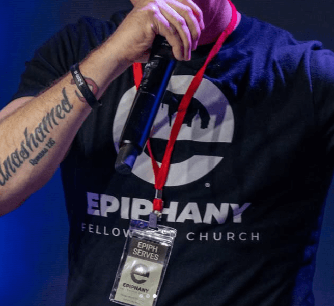 Speaker wearing Epiphany Fellowship Church t-shirt during service, showing how can churches use t-shirts to promote events and build unity.