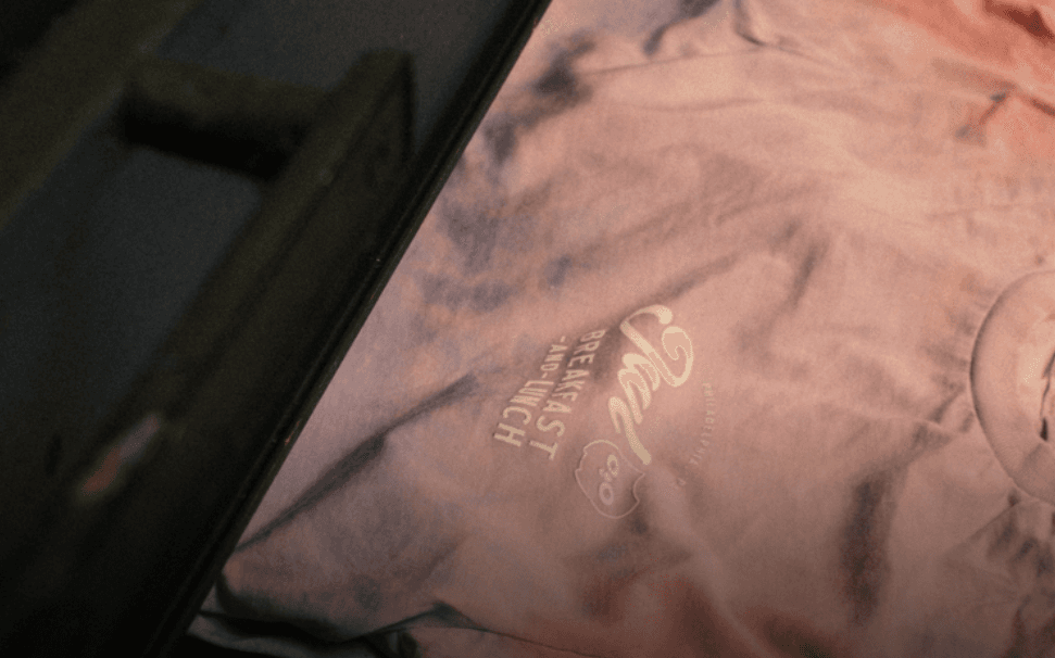 Tie-dye staff shirt design for Rob Kang Owl Breakfast, highlighting creative custom apparel used for restaurant branding.