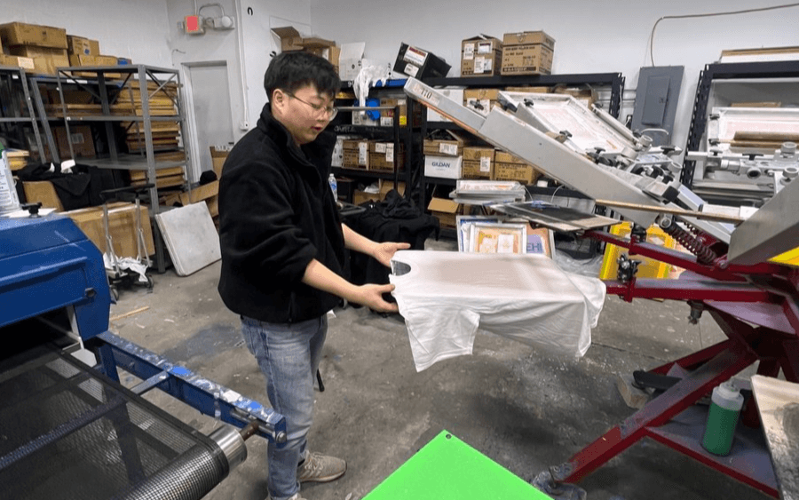 Screen printing process at Tee Vision Printing, producing custom uniforms for Rob Kang Owl Breakfast restaurant staff.