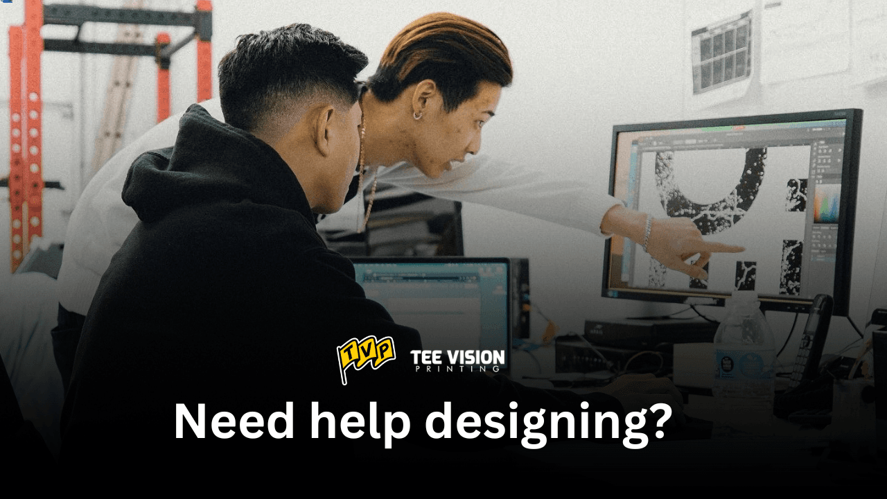 Design session with Tee Vision Printing—two creatives reviewing artwork on screen as they refine what makes an apparel standout for the summer drop.