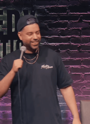 Martin Armini on stage wearing his “HeyGuys” shirt, a fan-favorite from Martin Armini's custom printed merch line.