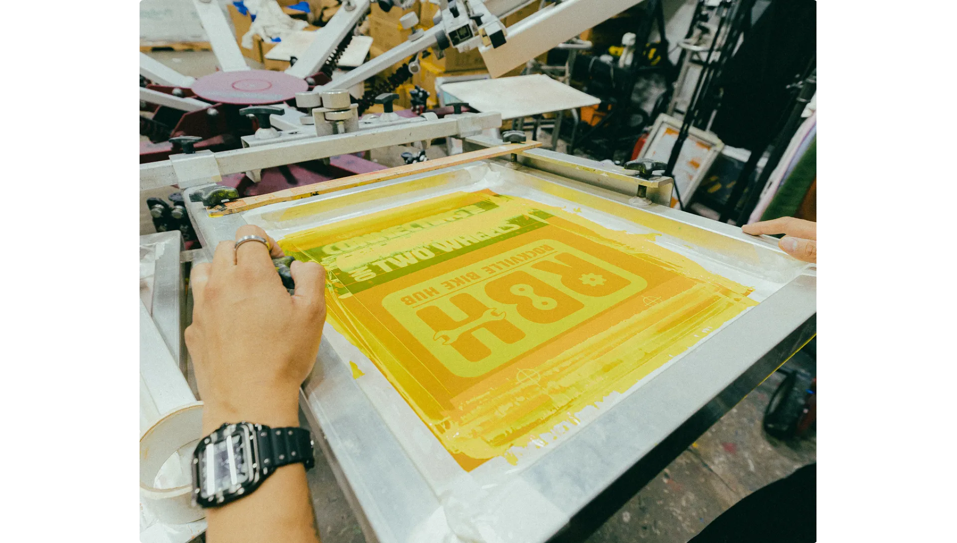 Screen printing process showing yellow ink application