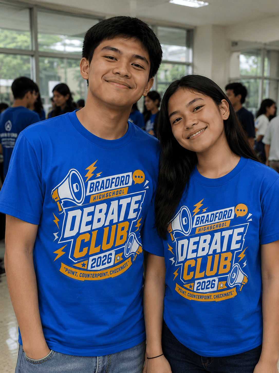 Two students wearing custom royal blue Bradford Highschool Debate Club t-shirts
