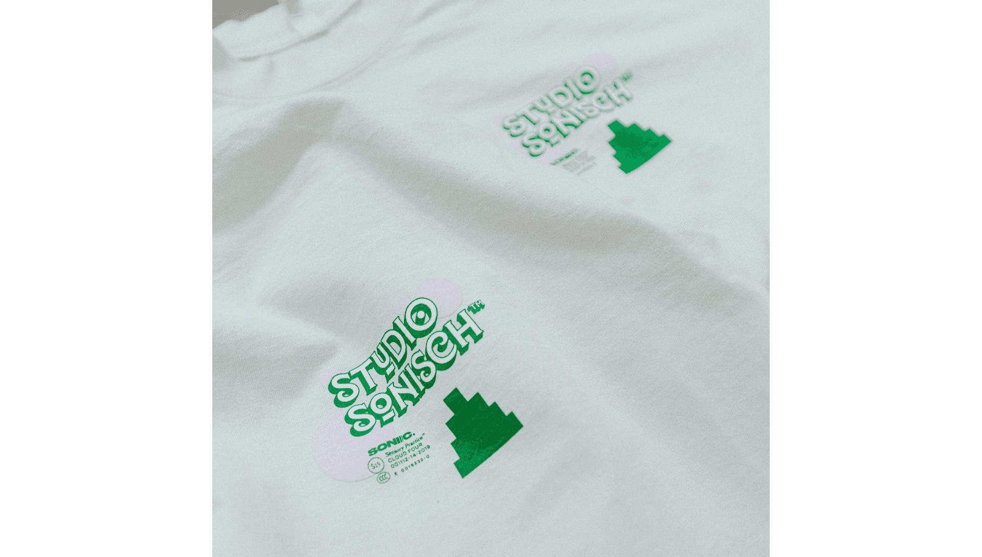 White t-shirt with green leaf designs