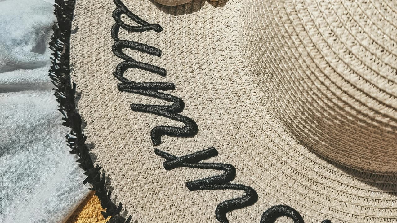 Our apparel design services go beyond shirts to include custom graphic design apparel like this embroidered summer sun hat.