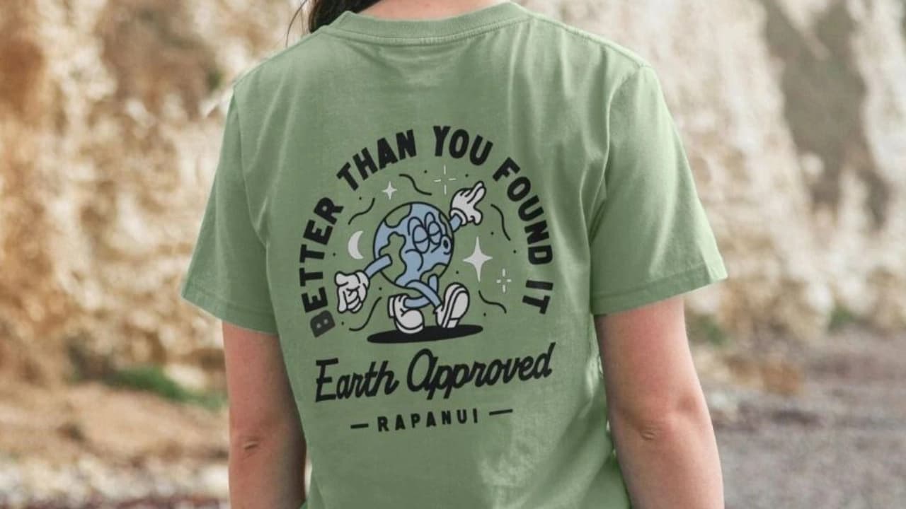 Back of a green t-shirt with "BETTER THAN YOU FOUND IT Earth Approved" graphic, a custom t-shirt design.