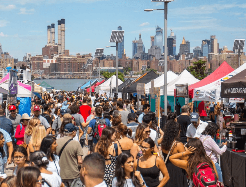 Lively street festival scene where fans discovered Custom Screen-Printed T Shirts for Rokstar Chicken, blending food culture with fashion.