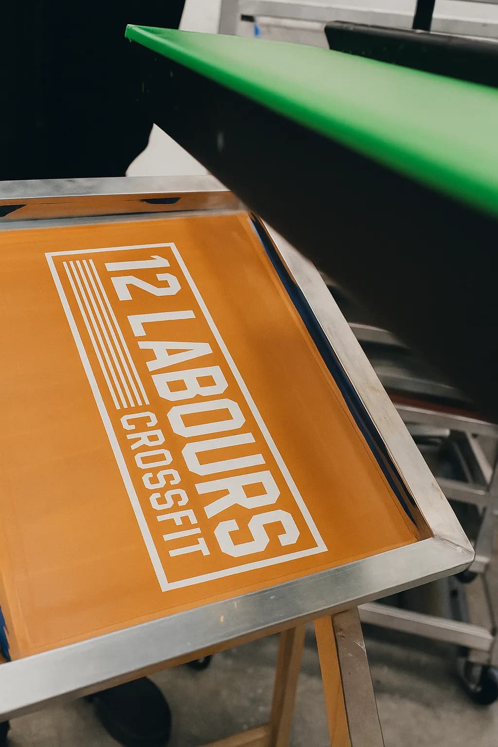 Screen printing setup with the 12 LABOURS CROSSFIT screen prepared for production, highlighting the screen printing process that helps make an apparel standout.