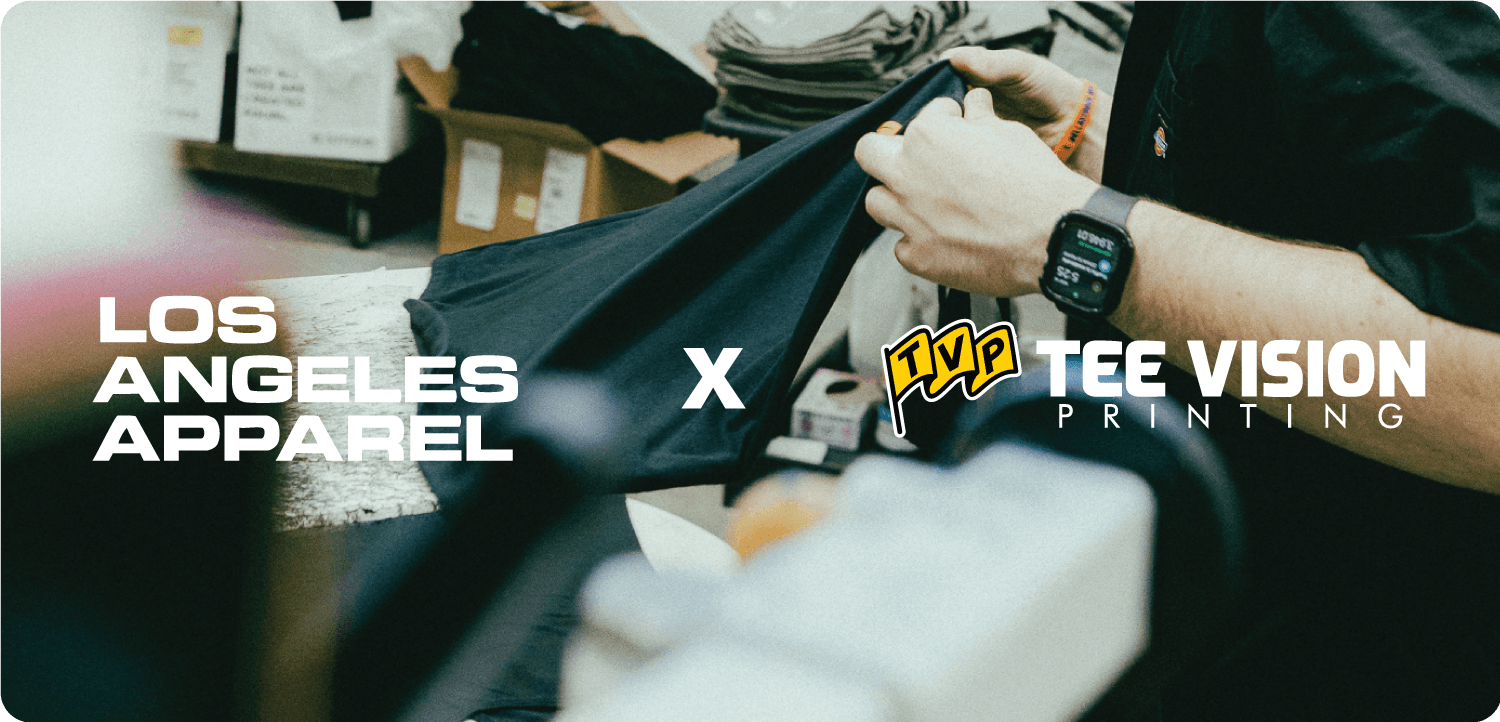 Quality check of black Los Angeles Apparel x Tee Vision Printing t‑shirt in production facility, highlighting custom apparel collaboration