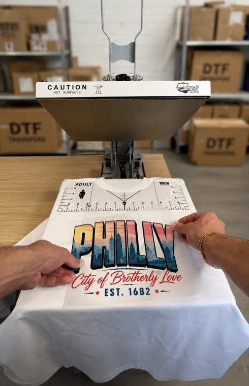 DTF transfer prints being applied to garments