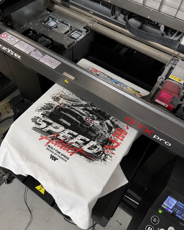 DTG printer printing a full-color design on a t-shirt