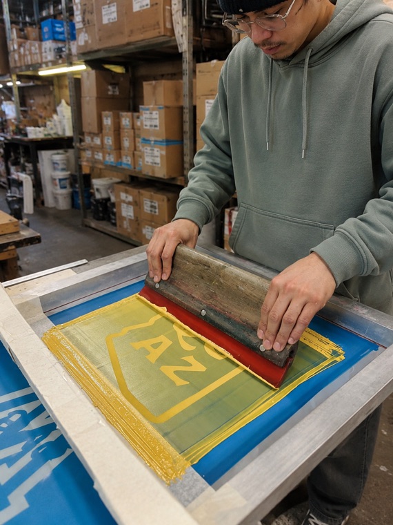 Custom screen printing press with t-shirts being printed