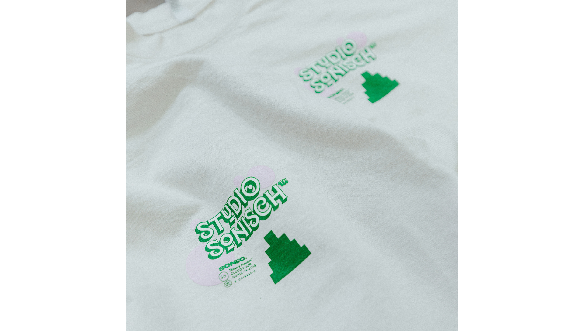 White t-shirt with green leaf designs