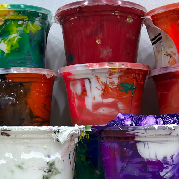 Colorful paint buckets for screen printing, ideal for custom t-shirt design and personalized apparel.